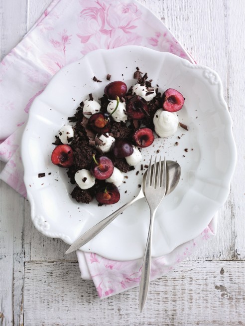 Smashed chocolate licorice meringues with whipped cream and cherries